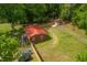 Aerial view of brick home, manicured yard, privacy fence, and storage shed at 774 Salem Church Rd, Sanford, NC 27330