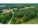 Aerial view of a red brick home with privacy fence, surrounded by lush greenery at 774 Salem Church Rd, Sanford, NC 27330