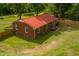 An aerial view of the red brick home featuring a spacious backyard with privacy fence at 774 Salem Church Rd, Sanford, NC 27330