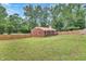 Expansive backyard featuring lush green lawn, full privacy fence, and a red brick home at 774 Salem Church Rd, Sanford, NC 27330