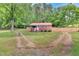 Exterior view of a brick home with a red roof and a wooden fence at 774 Salem Church Rd, Sanford, NC 27330