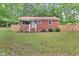 Charming brick home with a bright red roof and well-manicured lawn at 774 Salem Church Rd, Sanford, NC 27330