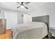 Main bedroom with hardwood floors, a ceiling fan, and a gray headboard at 774 Salem Church Rd, Sanford, NC 27330