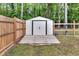 A well-maintained storage shed with a wooden deck, enclosed by a secure wooden fence at 774 Salem Church Rd, Sanford, NC 27330