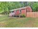 Brick home with a white railing leading to the entrance and a wooden fence at 774 Salem Church Rd, Sanford, NC 27330