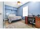 Blue bedroom with carpet and a desk area at 1022 Early Rise St St, Raleigh, NC 27610