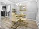 Elegant dining area featuring modern furnishings, a stylish chandelier and decorative mirror at 1022 Early Rise St St, Raleigh, NC 27610