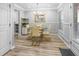 Dining room featuring a glass table, four chairs, light gray walls and an entry door at 1022 Early Rise St St, Raleigh, NC 27610