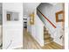Hallway featuring wood staircase, neutral paint, and entry to the kitchen area at 1022 Early Rise St St, Raleigh, NC 27610