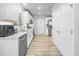 Well-lit kitchen with white cabinets, stainless steel appliances, and modern finishes at 1022 Early Rise St St, Raleigh, NC 27610