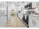 Bright kitchen featuring modern appliances, white cabinetry, and sleek gold hardware at 1022 Early Rise St St, Raleigh, NC 27610