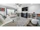 Bright living room with a fireplace, ceiling fan, built-in shelves, and plush seating at 1022 Early Rise St St, Raleigh, NC 27610