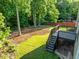 Spacious backyard featuring a deck with stairs leading down to a grassy area at 109 Highland Mist Cir, Apex, NC 27539