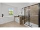 Modern bathroom featuring a tub, separate glass-enclosed shower, and natural light from the window at 109 Highland Mist Cir, Apex, NC 27539
