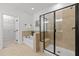 Bathroom featuring a walk-in shower with glass door, soaking tub, and tiled walls at 109 Highland Mist Cir, Apex, NC 27539