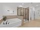 Well-lit bathroom with separate soaking tub and shower featuring tile accents and modern fixtures at 109 Highland Mist Cir, Apex, NC 27539