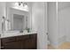 Bathroom showcasing dark cabinets, a white countertop, a large mirror, and natural light at 109 Highland Mist Cir, Apex, NC 27539