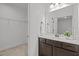 Bathroom boasts a dark vanity with white countertop, large mirror, and a closet behind at 109 Highland Mist Cir, Apex, NC 27539