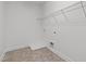 Empty closet space with vinyl flooring, wire shelving, and a utility sink connection at 109 Highland Mist Cir, Apex, NC 27539