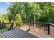 An expansive wooden deck overlooks a lush green backyard with mature trees at 109 Highland Mist Cir, Apex, NC 27539