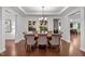Elegant dining room showcasing hardwood floors, a chandelier, and a spacious layout perfect for entertaining guests at 109 Highland Mist Cir, Apex, NC 27539
