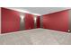 Versatile empty room with a neutral carpet and bold accent walls; ideal for a home office or entertainment area at 109 Highland Mist Cir, Apex, NC 27539