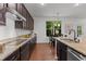 This kitchen features granite counters, stainless appliances, and dark wood cabinets at 109 Highland Mist Cir, Apex, NC 27539