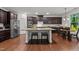 Stylish kitchen featuring stainless steel appliances, a granite island with seating, and abundant cabinet space at 109 Highland Mist Cir, Apex, NC 27539