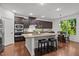 Modern kitchen featuring stainless steel appliances, a granite island with seating, and ample cabinet space at 109 Highland Mist Cir, Apex, NC 27539