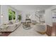 Bright living room with hardwood floors, large windows and comfortable seating, perfect for relaxing and entertaining at 109 Highland Mist Cir, Apex, NC 27539