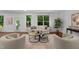 Bright living room featuring large windows, hardwood flooring, modern decor, and ample natural light at 109 Highland Mist Cir, Apex, NC 27539