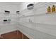 Organized walk-in pantry with metal shelving, providing ample storage space for kitchen essentials and supplies at 109 Highland Mist Cir, Apex, NC 27539