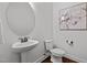 Modern powder room with a pedestal sink, toilet, and decorative mirror, offering a clean and stylish design at 109 Highland Mist Cir, Apex, NC 27539