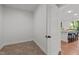 This bonus room features tile floors and a view into the kitchen and dining spaces at 109 Highland Mist Cir, Apex, NC 27539