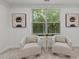 This sitting area features large windows offering lots of natural light and wooded scenery at 109 Highland Mist Cir, Apex, NC 27539