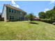 Expansive backyard features a lush lawn, mature trees, and a patio area, providing ample space for outdoor activities at 112 Victorian Oaks Dr, Durham, NC 27713