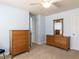Neutral bedroom with carpet, wood dressers, white doors and trim, light blue walls at 112 Victorian Oaks Dr, Durham, NC 27713