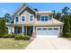 Charming two-story home boasts a manicured lawn, stone accents, and a convenient two-car garage at 112 Victorian Oaks Dr, Durham, NC 27713
