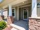 Welcoming front porch with stone accents, providing a charming entrance to the home at 112 Victorian Oaks Dr, Durham, NC 27713