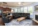Open living room with kitchen views, a fireplace, and expansive windows filling the space with light at 112 Victorian Oaks Dr, Durham, NC 27713