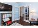 Cozy home office featuring French doors, ample storage, and comfortable leather seating at 112 Victorian Oaks Dr, Durham, NC 27713