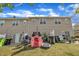 Backyard featuring a patio, playhouse, and a lush lawn in a townhome community at 114 Montview Way, Knightdale, NC 27545