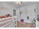 This bedroom features a lofted bed, colorful decor, and access to closet and door at 114 Montview Way, Knightdale, NC 27545