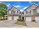 Two-story townhome exterior featuring stone accents, a two car garage, and neutral color siding at 114 Montview Way, Knightdale, NC 27545