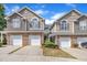 Two-story townhome exterior featuring stone accents, a two car garage, and neutral color siding at 114 Montview Way, Knightdale, NC 27545