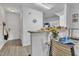 Open concept kitchen featuring a peninsula, white cabinetry, hardwood floors, and neutral paint at 114 Montview Way, Knightdale, NC 27545