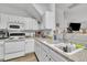 Kitchen featuring white cabinetry, laminate countertops, appliances, and hardwood flooring at 114 Montview Way, Knightdale, NC 27545