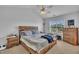 Bright main bedroom features a ceiling fan, bedside tables, and a chest of drawers at 114 Montview Way, Knightdale, NC 27545