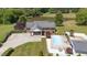 Aerial view of the property showcasing the house, pool, pond, and surrounding landscape at 1199 Cesar Ct, Graham, NC 27253