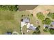 Stunning aerial view of a home with a private pool, pond with dock, and lush green landscaping at 1199 Cesar Ct, Graham, NC 27253
